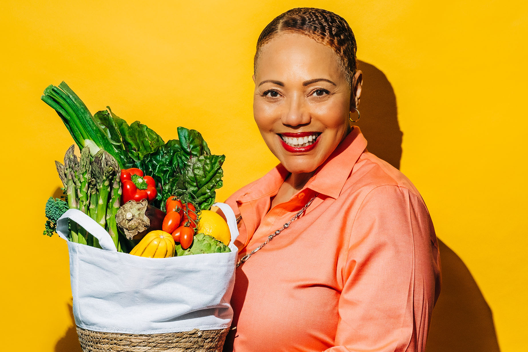 nina curtis holding a bag of vegetables
