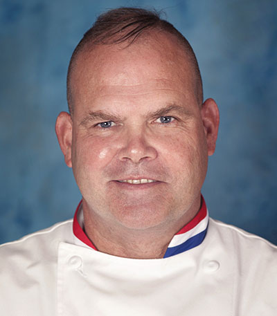 Stephen sullivan wearing a shirt with a red, white and blue striped collar